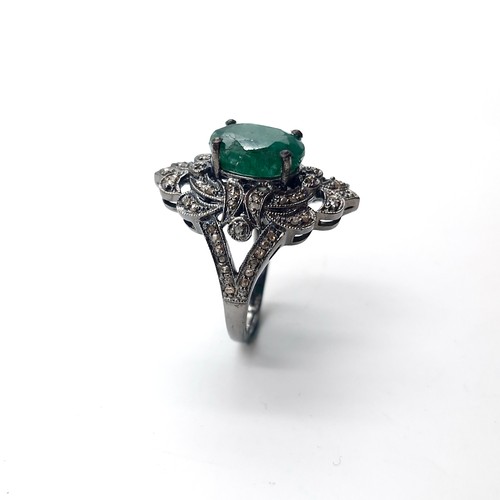 583 - Star Lot : An emerald stone ring set with diamond mount and set in sterling silver. Size - O. Weight... 