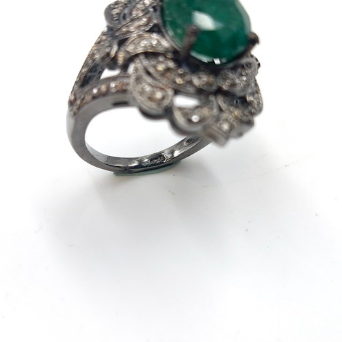 583 - Star Lot : An emerald stone ring set with diamond mount and set in sterling silver. Size - O. Weight... 