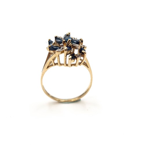 585 - Star Lot : An unusual large nine carat gold vintage sapphire & diamond ring. Size - N. Weight - 3.15... 