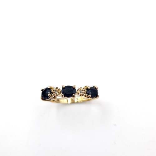 588 - Star Lot : A nine carat gold three stone large sapphire & diamond ring. Size - N 1/2. Weight - 2.75 ... 