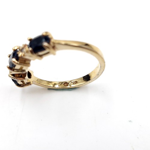 588 - Star Lot : A nine carat gold three stone large sapphire & diamond ring. Size - N 1/2. Weight - 2.75 ... 