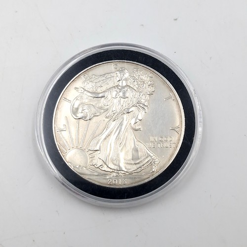 620 - An encapsulated Walking liberty USA one ounce fine silver one dollar coin dated 2013.