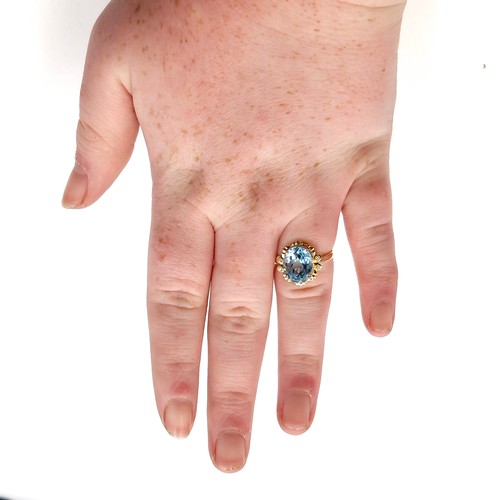 634 - Star Lot: A most attractive 5.01ct blue topaz stone set with 0.013ct diamonds, mounted in 14 carat g... 