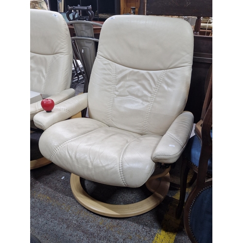 753 - Cream leather swivel armchair with wooden base, featuring plush cushioning and ergonomic design.