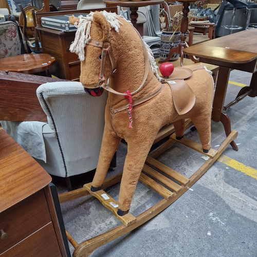 701 - Star Lot : A charming vintage  rocking horse with a yarn mane and tail, wooden rockers, and leather ... 