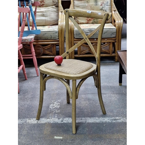 709 - A beautiful oak bent wood bistro chair with stylish cross back and rattan seat. RRP: €175 on the cur... 