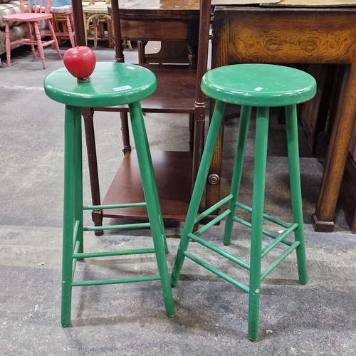 710 - A pair of green painted wooden bar / kitchen stools.