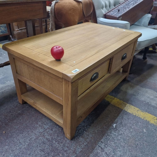 720 - Star Lot : A solid oak coffee table / tv stand featuring two good size drawers and shelf to base.