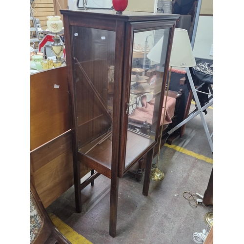 724 - An Edwardian style mahogany light up display cabinet mounted on wooden legs. Features glass panels o... 