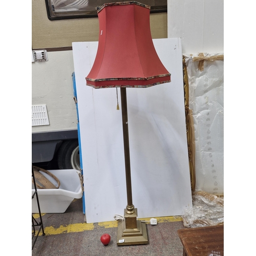 734 - A heavy vintage solid brass Corinthian column floor lamp paired with a red fabric shade with colourf... 