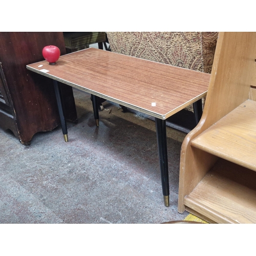 735 - A mid century coffee table with decorative gold trim around the top sat on tapered legs. Nice condit... 