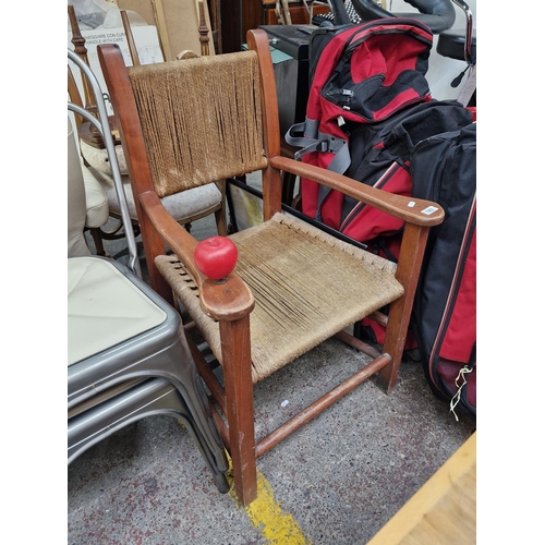 743 - A vintage solid wood chair featuring a lovely rush weaved sugan seat and back with turned supports.