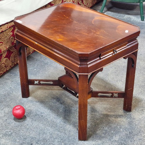 705 - An attractive flame mahogany side / coffee table with unusual open fretwork to stretcher and pull ou... 