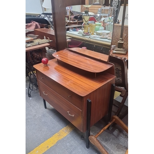 699 - Star Lot : Mid-Century Modern teak vanity with two drawers, elevated shelf, and large mirror. Featur... 