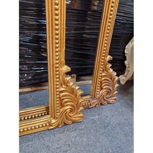 1409 - Two Elaborate gilt frames arched featuring ornate scroll and bead detailing.Approx 130cm wide and 12... 