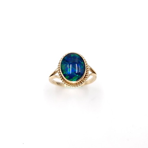 1 - Star Lot : A beautiful nine carat gold fire blue opal ring with dimpled surround. Size - K. Weight -... 