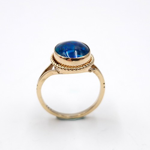 1 - Star Lot : A beautiful nine carat gold fire blue opal ring with dimpled surround. Size - K. Weight -... 