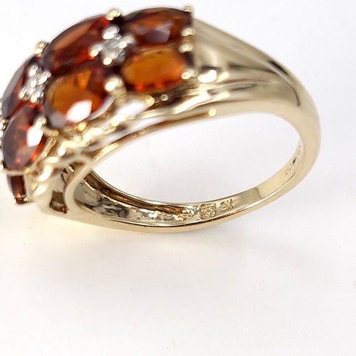 2 - Star Lot : A very impressive nine carat gold multi stone garnet ring. Size - M 1/2. Weight - 3.43 gr... 