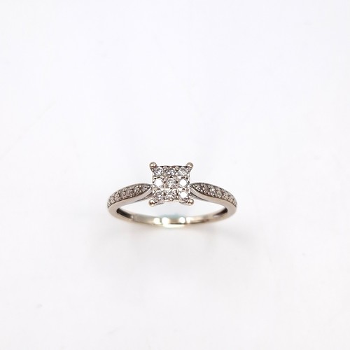 5 - Star Lot : A nine carat gold 15 stone diamond ring. Size - R. Weight - 2.25 grams.