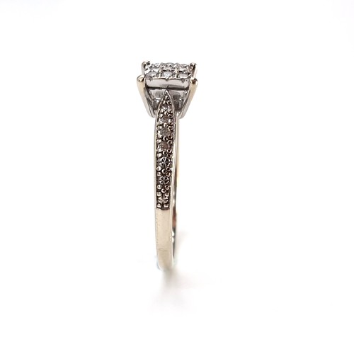 5 - Star Lot : A nine carat gold 15 stone diamond ring. Size - R. Weight - 2.25 grams.