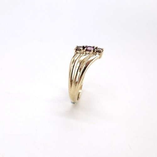 8 - Star Lot : A triple band nine carat gold gemstone ring. Size - O. Weight - 2.12 grams.