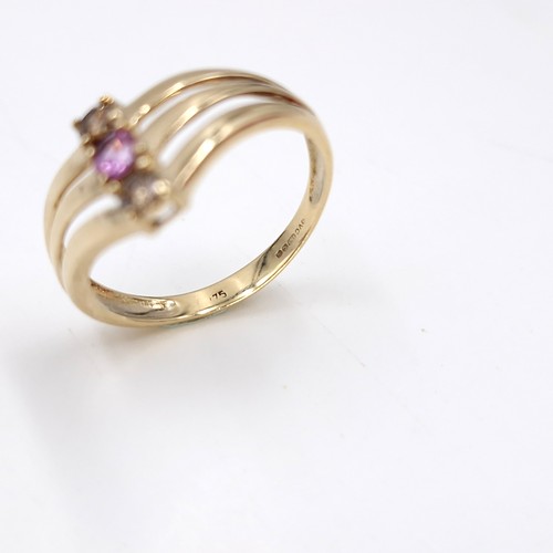 8 - Star Lot : A triple band nine carat gold gemstone ring. Size - O. Weight - 2.12 grams.