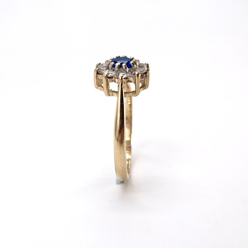 9 - A nine carat gold blue topaz flower ring. Size - M. Weight - 2 grams.