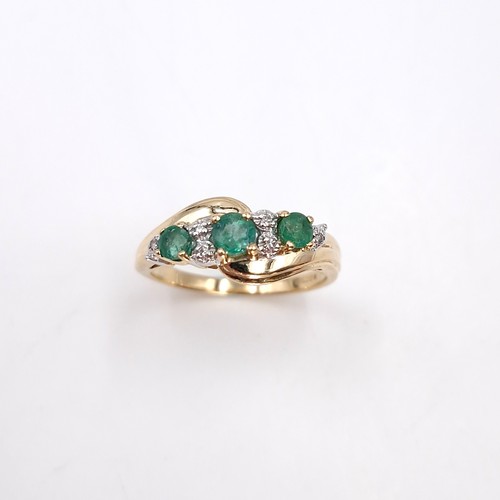 10 - Star Lot : A fabulous vintage  nine carat gold emerald and diamond twist mounted ring. Size - O. Wei... 