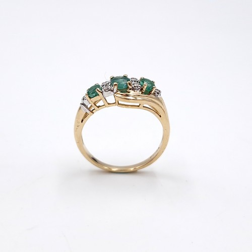 10 - Star Lot : A fabulous vintage  nine carat gold emerald and diamond twist mounted ring. Size - O. Wei... 