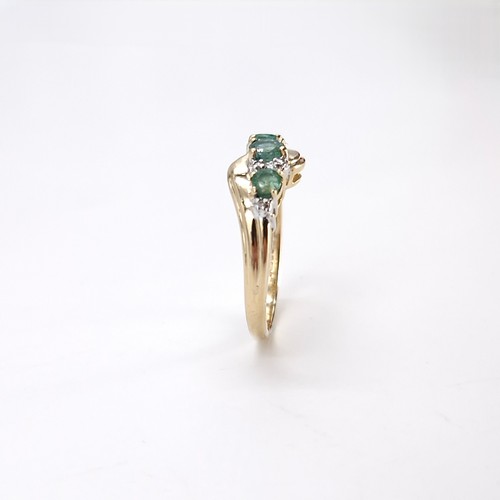 10 - Star Lot : A fabulous vintage  nine carat gold emerald and diamond twist mounted ring. Size - O. Wei... 