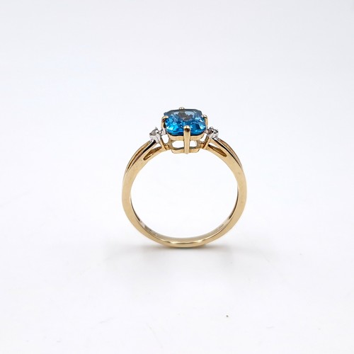 13 - Star Lot : An unusual raised nine carat gold blue topaz and diamond ring. Size - O. Weight - 2 grams... 