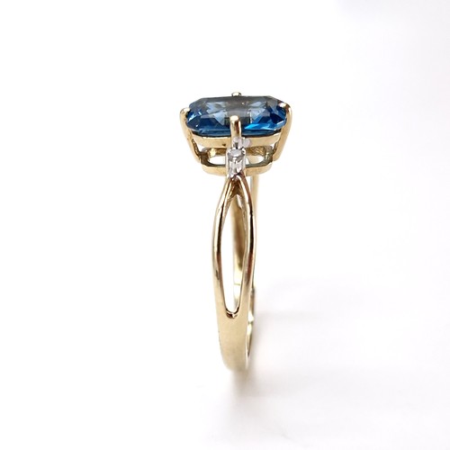 13 - Star Lot : An unusual raised nine carat gold blue topaz and diamond ring. Size - O. Weight - 2 grams... 