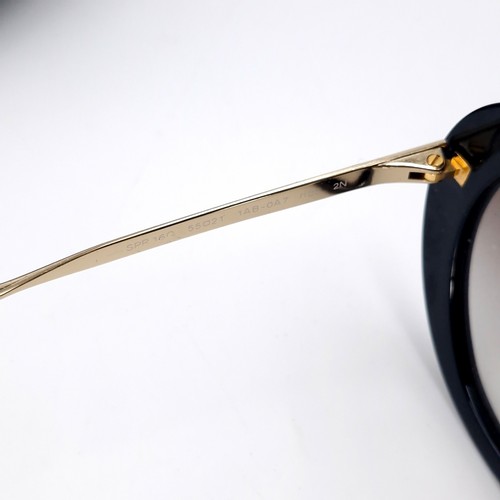 35 - A pair of designer original Prada Made in Italy sunglasses with metal frames. Comes in original case... 