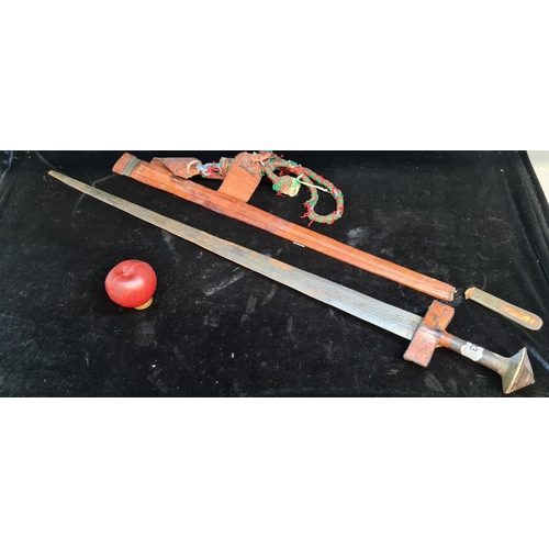 103 - Star Lot : A mid 20th century African turareg sword and scabbard. Selling online for €250+. (damage ... 