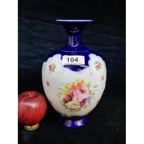 104 - A very pretty Victoria ware Austria porcelain vase featuring delicate hand painted floral design. In... 