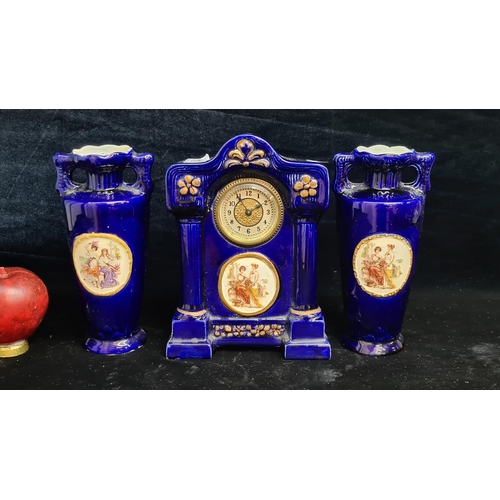 118 - A trio of antique JS Austria porcelain pieces, including a mantel clock accompanied by a pair of mat... 