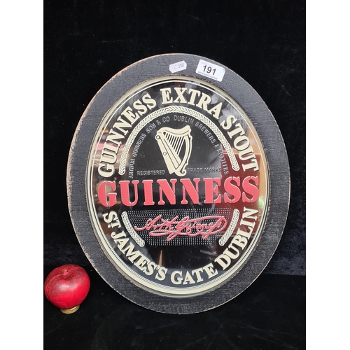 191 - An oval Guinness branded advertising pub mirror.