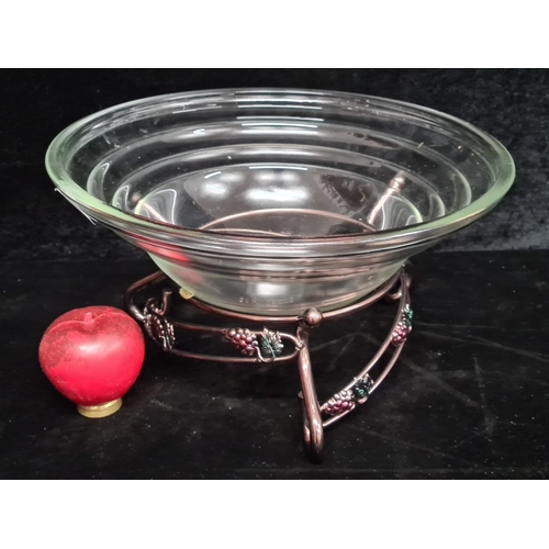 195 - A large vintage fruit bowl with a footed metal stand featuring grapes motifs.