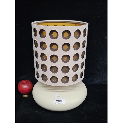 200 - A quirky mid century style table lamp featuring a bold and distinctive design shade.