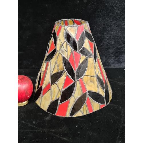 213 - A Tiffany style stained glass panel lamp shade in rich deep tones.