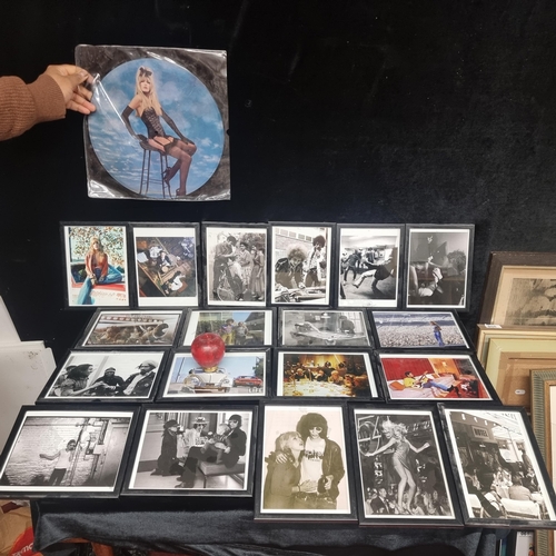 216 - A box containing nineteen vintage photographs which includes a number of iconic musicians including ... 