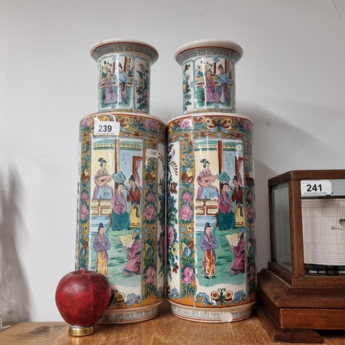 239 - A striking pair of large Chinese porcelain canton / famille rose style vases. Small chip to base of ... 