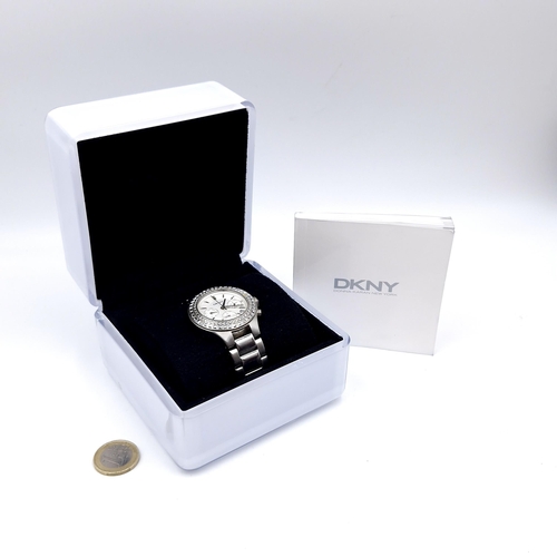 19 - A DKNY Donna Karen New York, chronograph wristwatch with original metal bracelet together with instr... 