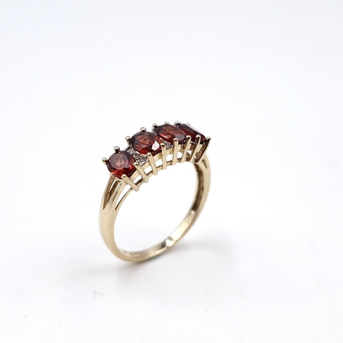 31 - Star Lot : A nine carat gold garnet ring set with diamonds. Ring size - P. Weight - 2.36 grams.