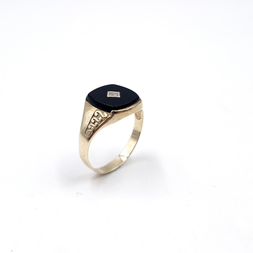 33 - Star lot : A nine carat gold gents onyx and diamond signet ring. Size - S. Weight - 2.54 grams.