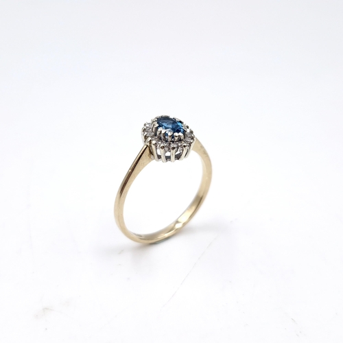 35 - Star lot : A nine carat gold blue topaz and diamond set ring. Size - P. Weight - 2.28 grams.