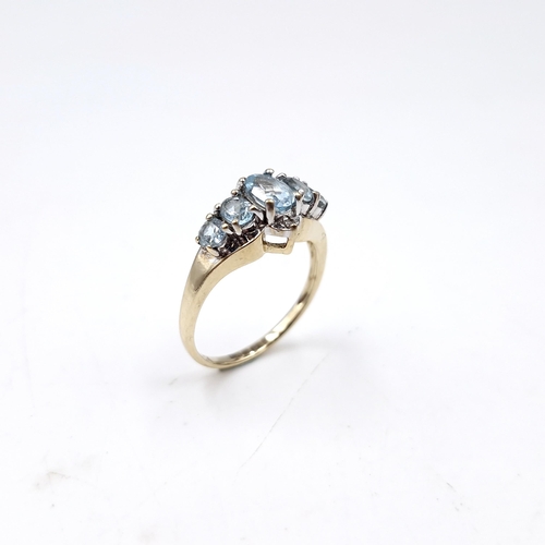 36 - Star Lot : A nine carat gold blue topaz cluster set ring. Size - M 1/2. Weight - 2.6 grams.