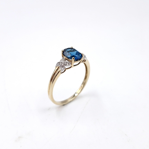 38 - Star Lot :  A beautiful nine carat gold faceted cut blue  topaz and diamond ring. Size - R. Weight -... 