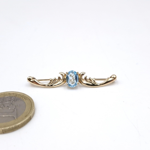 39 - A vey pretty nine carat gold blue topaz brooch. Length - 4 cms. Weight - 2.36 grams. Pin intact.