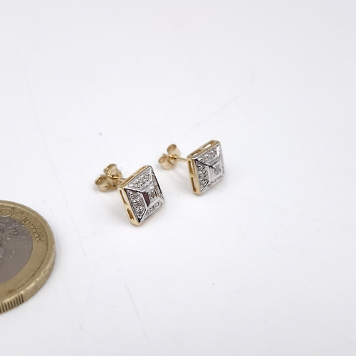 41 - Star Lot : A pair of nine carat gold diamond stud earrings. Weight - 1.48 grams.